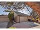 Charming home exterior featuring a two-car garage, mature trees, and inviting landscaping at 7000 W Stetson Pl # 9, Littleton, CO 80123