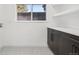 Well-lit laundry room with modern cabinets, quartz countertop, patterned floors and a large window at 7000 W Stetson Pl # 9, Littleton, CO 80123