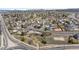 Overhead shot of a residential area with winding streets, mature trees, and mountain views at 1206 Baldwin Park Cir, Castle Rock, CO 80104