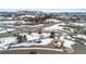 Aerial view of snow covered houses near a major intersection, with a mountain in the background at 1206 Baldwin Park Cir, Castle Rock, CO 80104