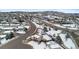 A snow-covered neighborhood with houses and streets is captured from an aerial view at 1206 Baldwin Park Cir, Castle Rock, CO 80104