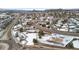 Aerial view of homes in a snow-covered neighborhood, surrounded by trees and streets at 1206 Baldwin Park Cir, Castle Rock, CO 80104