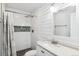 Bright bathroom features a shower with tile surround and vanity with white cabinets at 1206 Baldwin Park Cir, Castle Rock, CO 80104