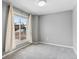 Sunlit bedroom showcasing a large window with neutral curtains and cozy carpet at 1206 Baldwin Park Cir, Castle Rock, CO 80104