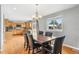 Inviting dining room with hardwood floors, stylish chandelier, and a view to the kitchen at 1206 Baldwin Park Cir, Castle Rock, CO 80104