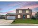 Charming two-story home with a well-maintained lawn and attached garage, capturing its curb appeal at 1206 Baldwin Park Cir, Castle Rock, CO 80104