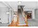 Inviting foyer with hardwood flooring and staircase leading to upper level at 1206 Baldwin Park Cir, Castle Rock, CO 80104