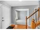 Bright foyer with hardwood floors, staircase, and view into living room at 1206 Baldwin Park Cir, Castle Rock, CO 80104