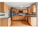 Well-appointed kitchen featuring oak cabinets, modern appliances, and tile backsplash at 1206 Baldwin Park Cir, Castle Rock, CO 80104