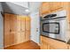 Kitchen features stainless oven, light wood cabinetry, and access to mudroom or patio at 1206 Baldwin Park Cir, Castle Rock, CO 80104