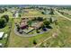 Scenic aerial view showcasing the property with its large lot, white fence, and surrounding greenery at 17450 E 14Th Dr, Aurora, CO 80011