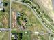 Overhead view showing the property's layout with its house, outbuildings, and spacious, well-maintained land at 17450 E 14Th Dr, Aurora, CO 80011