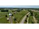 Elevated aerial view of the property displaying the extensive land with outbuildings and surrounding area at 17450 E 14Th Dr, Aurora, CO 80011