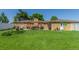 Vast backyard featuring a large lawn, patio, and charming pergola-covered outdoor dining area at 17450 E 14Th Dr, Aurora, CO 80011