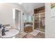 Bathroom featuring dual sinks, granite countertops, a soaking tub, and a glass-enclosed shower at 17450 E 14Th Dr, Aurora, CO 80011
