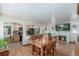 Open-concept dining room showing wood floors, modern lighting, and an open archway to the kitchen at 17450 E 14Th Dr, Aurora, CO 80011