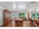 Dining area with wooden floors and large windows providing plenty of natural light and access to the kitchen at 17450 E 14Th Dr, Aurora, CO 80011