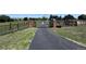 Long paved driveway leading through a gated entrance, ensuring privacy and security at 17450 E 14Th Dr, Aurora, CO 80011