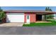 View of a red detached garage with carport, white garage door and entry door at 17450 E 14Th Dr, Aurora, CO 80011
