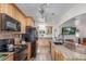 Well-lit kitchen with stainless steel appliances, granite countertops, wood cabinets and an undermounted sink at 17450 E 14Th Dr, Aurora, CO 80011