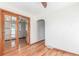 Cozy living room featuring hardwood floors, wood trim, and glass paneled french doors at 17450 E 14Th Dr, Aurora, CO 80011