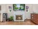 Cozy living room featuring a fireplace, hardwood floors, and natural light from the windows at 17450 E 14Th Dr, Aurora, CO 80011