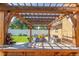 Outdoor pergola with seating area, table, and lush green yard at 17450 E 14Th Dr, Aurora, CO 80011