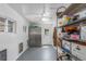 Bright storage room with built-in shelving, stainless steel cabinet, and ample space at 17450 E 14Th Dr, Aurora, CO 80011