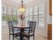 Cozy dining area with round wood table and chairs set by large window with shutter shades at 6617 S Reed Way # C, Littleton, CO 80123