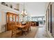 Spacious dining area with a large wooden table set, chandelier, and open flow to the living room and kitchen at 6617 S Reed Way # C, Littleton, CO 80123