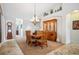 Elegant dining room with a wooden table, hutch, and decoratively tiled flooring leading to other areas of the home at 6617 S Reed Way # C, Littleton, CO 80123