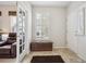 Inviting foyer featuring tile flooring, a storage bench by a bright window, and a view into the adjacent living space at 6617 S Reed Way # C, Littleton, CO 80123