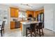 Well-lit kitchen with stainless steel appliances, granite countertops, and island with breakfast bar at 6617 S Reed Way # C, Littleton, CO 80123