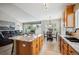 Open-concept kitchen showcasing island with granite countertop, cabinetry, and seamless flow to the living room at 6617 S Reed Way # C, Littleton, CO 80123