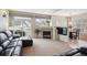 Bright living room featuring a modern fireplace, plush seating, and access to an outdoor patio through sliding glass doors at 6617 S Reed Way # C, Littleton, CO 80123