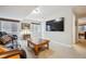 Cozy living room with plush seating, carpet, a large screen TV and plenty of natural light at 6617 S Reed Way # C, Littleton, CO 80123