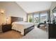 Spacious main bedroom featuring vaulted ceiling, large windows, and comfortable furniture at 6617 S Reed Way # C, Littleton, CO 80123