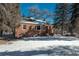 Brick ranch house with snowy yard and mature trees at 3750 S Ogden St, Englewood, CO 80113