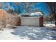 Detached brick garage with a white door, snow on the ground at 3750 S Ogden St, Englewood, CO 80113