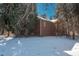 Brick house exterior with snowy yard and mature trees at 3750 S Ogden St, Englewood, CO 80113