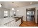 Bright kitchen featuring a farmhouse sink and white cabinetry at 3750 S Ogden St, Englewood, CO 80113