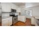 White kitchen with stainless steel appliances at 3750 S Ogden St, Englewood, CO 80113