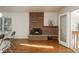 Living room with brick fireplace and hardwood floors at 3750 S Ogden St, Englewood, CO 80113