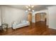 Living room with hardwood floors, light walls, and a neutral sofa at 3750 S Ogden St, Englewood, CO 80113