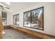 Bright sunroom with wood bench seating and large windows offering backyard views at 3750 S Ogden St, Englewood, CO 80113