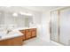 Main bathroom with double vanity and walk-in shower at 9691 Independence Dr, Westminster, CO 80021