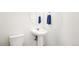 Clean and bright bathroom with pedestal sink and toilet at 9691 Independence Dr, Westminster, CO 80021