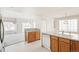 Open kitchen features oak cabinets and a breakfast bar at 9691 Independence Dr, Westminster, CO 80021