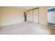 Spacious bedroom with neutral carpet, closet, and view to the attached bathroom featuring a shower at 18240 E Mexico Pl, Aurora, CO 80017