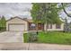 Charming single-Gathering home featuring a well-maintained lawn, mature tree, and a red brick entryway at 18240 E Mexico Pl, Aurora, CO 80017